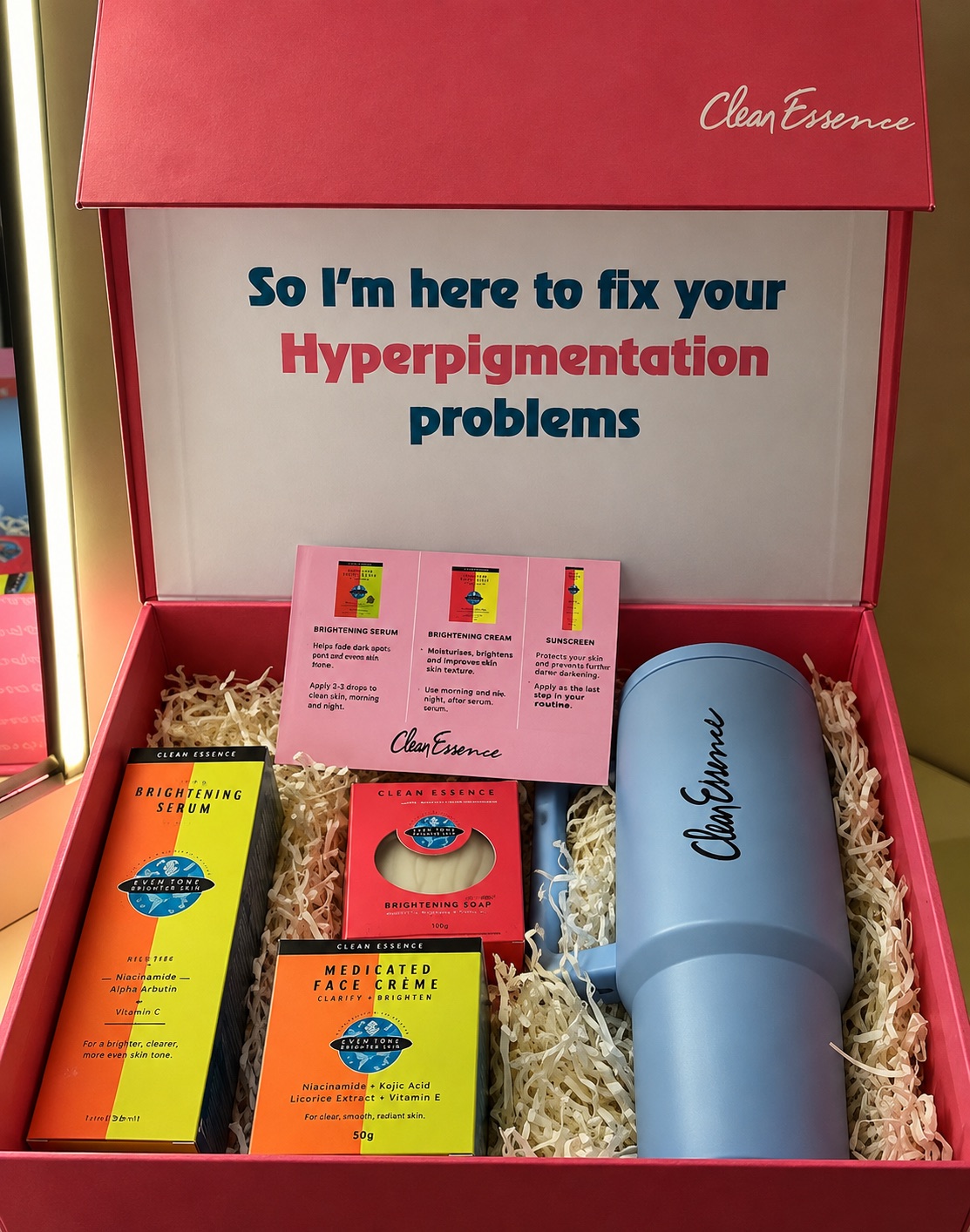 Clean Essence PR box: open pink gift box reading 'So I'm here to fix your Hyperpigmentation problems', with serum, face crème, soap and a branded tumbler