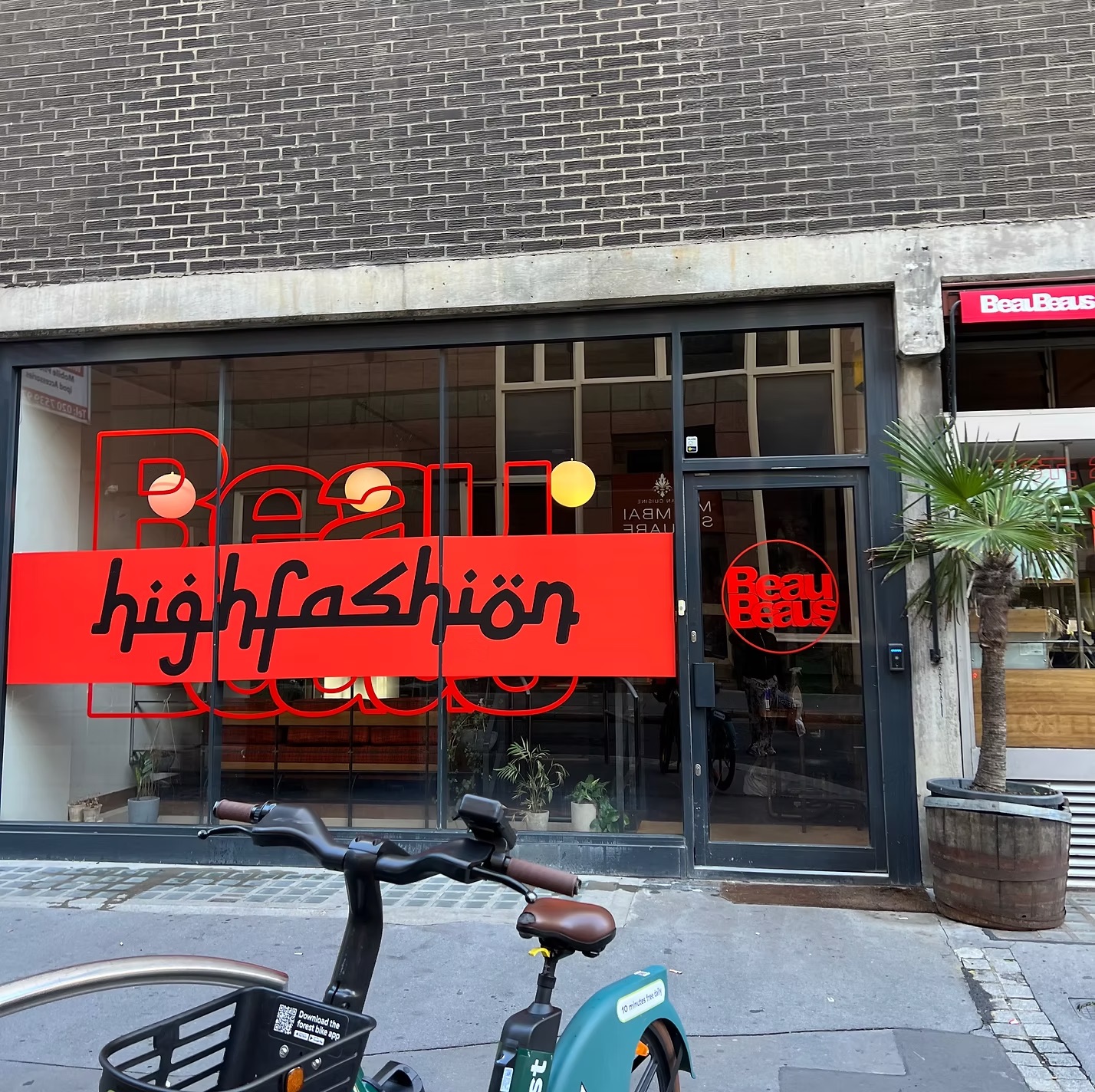 London storefront window with a large red 'highfashiön' banner and Beau Beaus branding on the glass