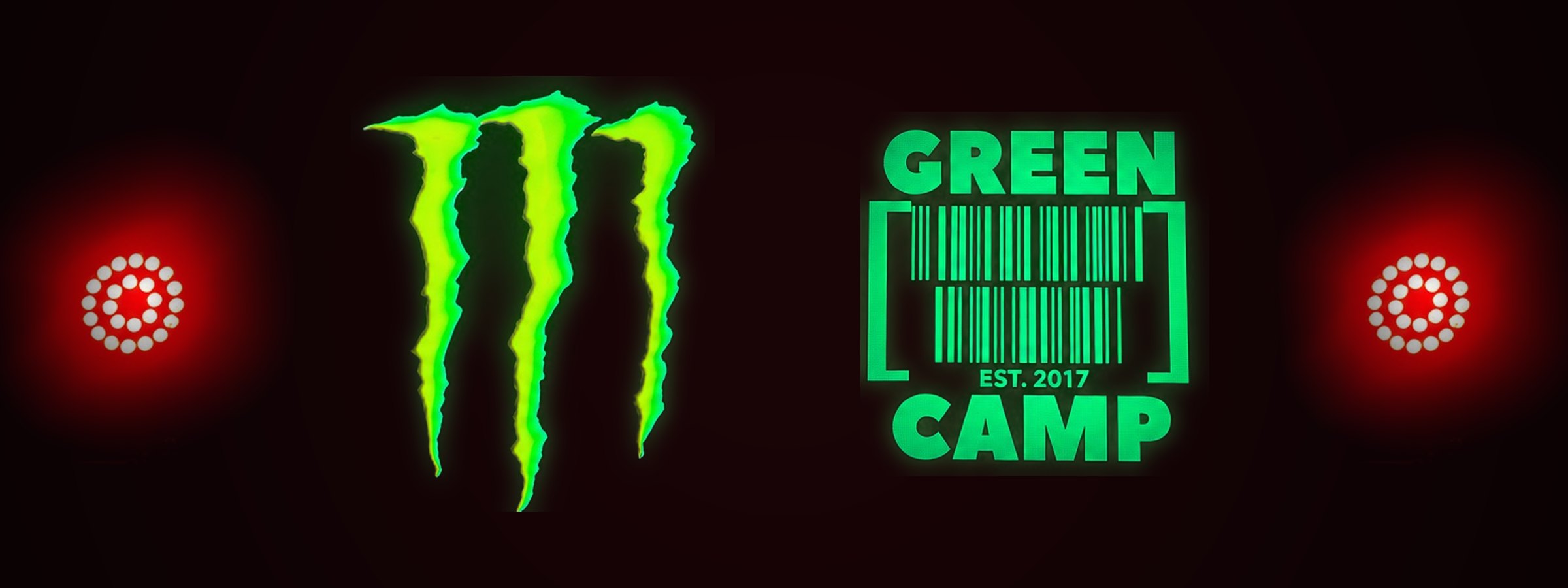 Monster Energy claw logo and the Green Camp logo side by side, glowing green on a dark stage